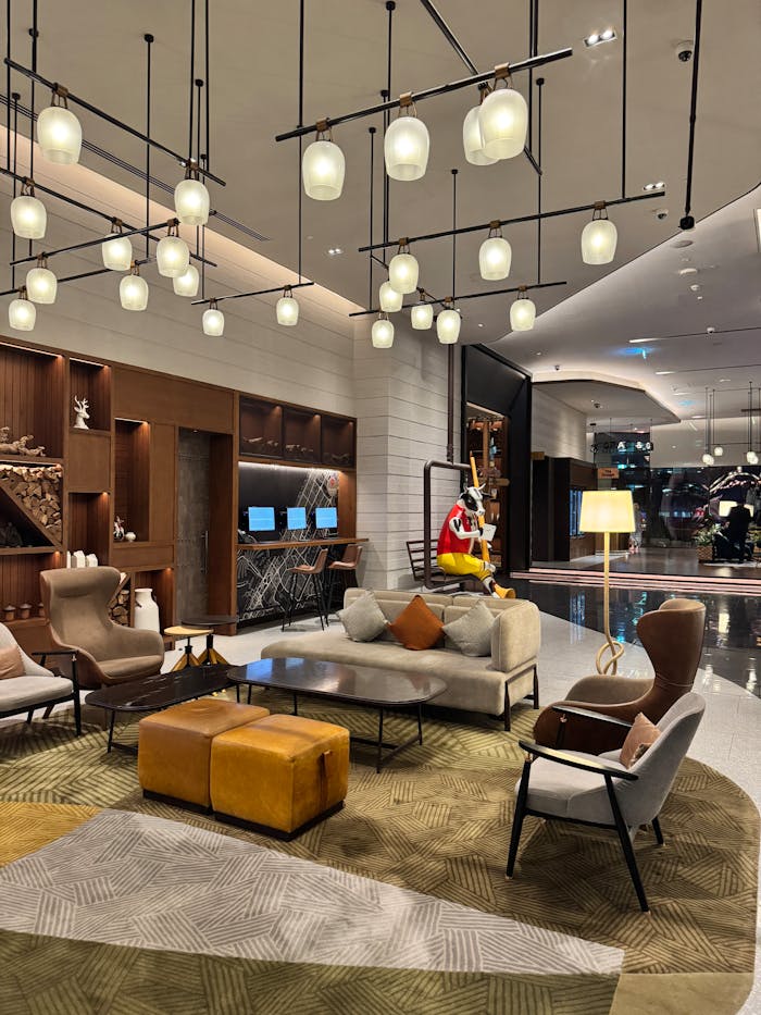 Elegant hotel lobby featuring chic furniture, ambient lighting, and contemporary design elements.